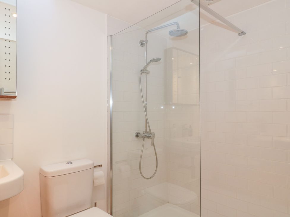 A bathroom featuring a shower and toilet at Spring View in Kingscote, Gloucestershire