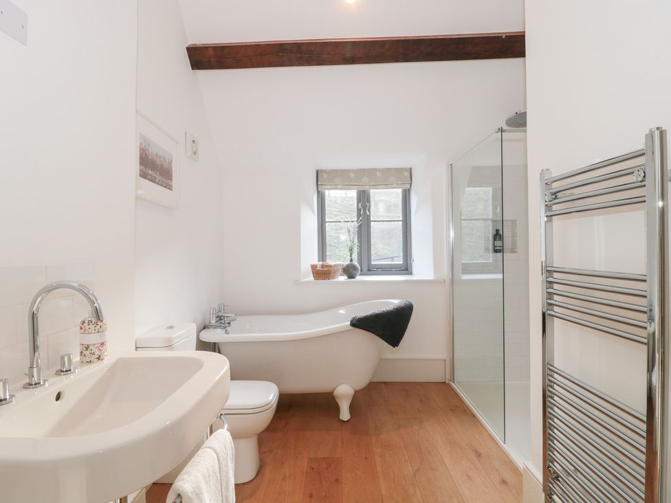 A bathroom with a bathtub and shower at Spring View in Kingscote, Gloucestershire