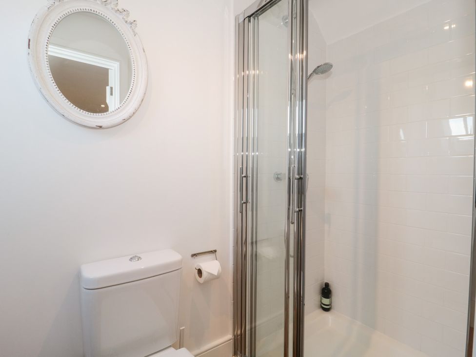 A bathroom with a shower and toilet at Spring View in Kingscote, Gloucestershire