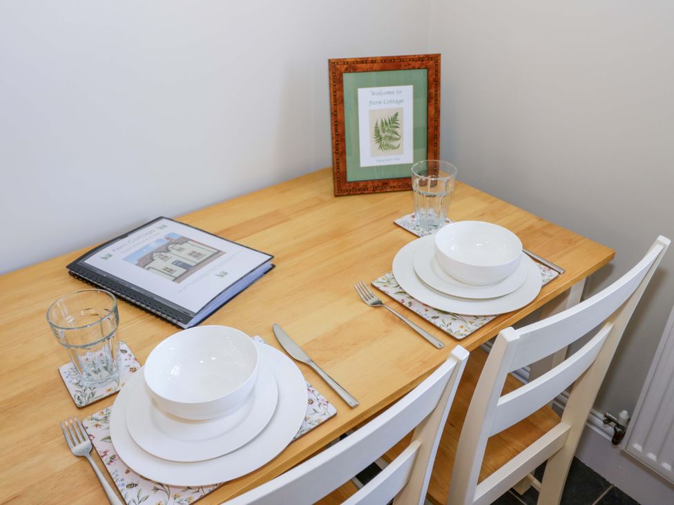 A dining table set with tableware at Fern Cottage in Lichfield