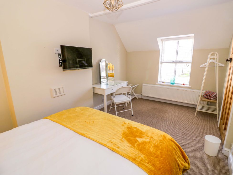 A bedroom with a bed and desk area at Fern Cottage, Lichfield