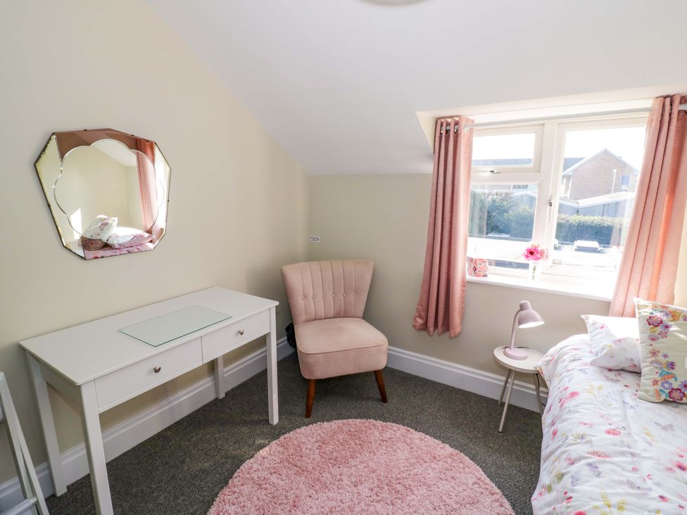 A bedroom with a desk, chair, bed and window at Fern Cottage in Lichfield