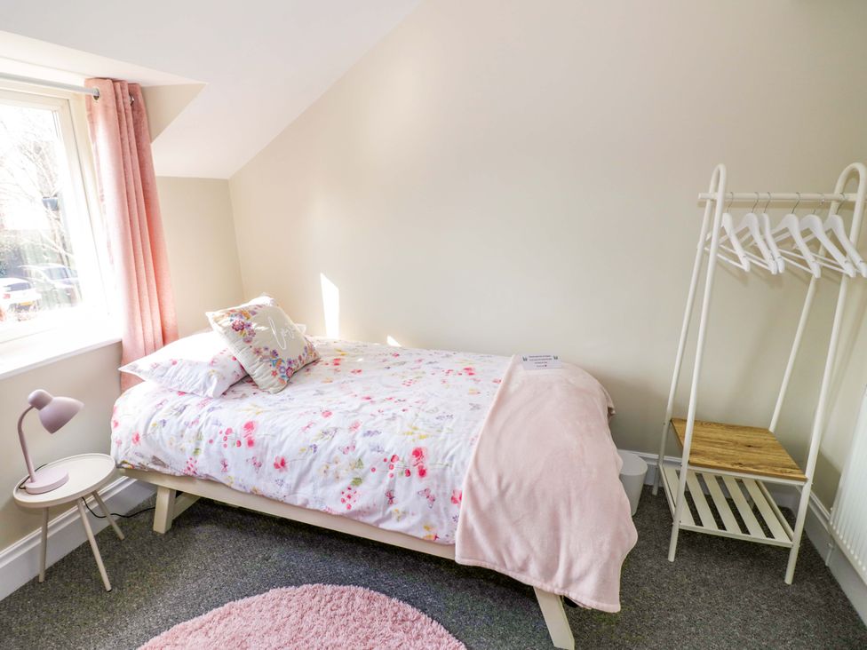 A bedroom with a bed and a window at Fern Cottage in Lichfield