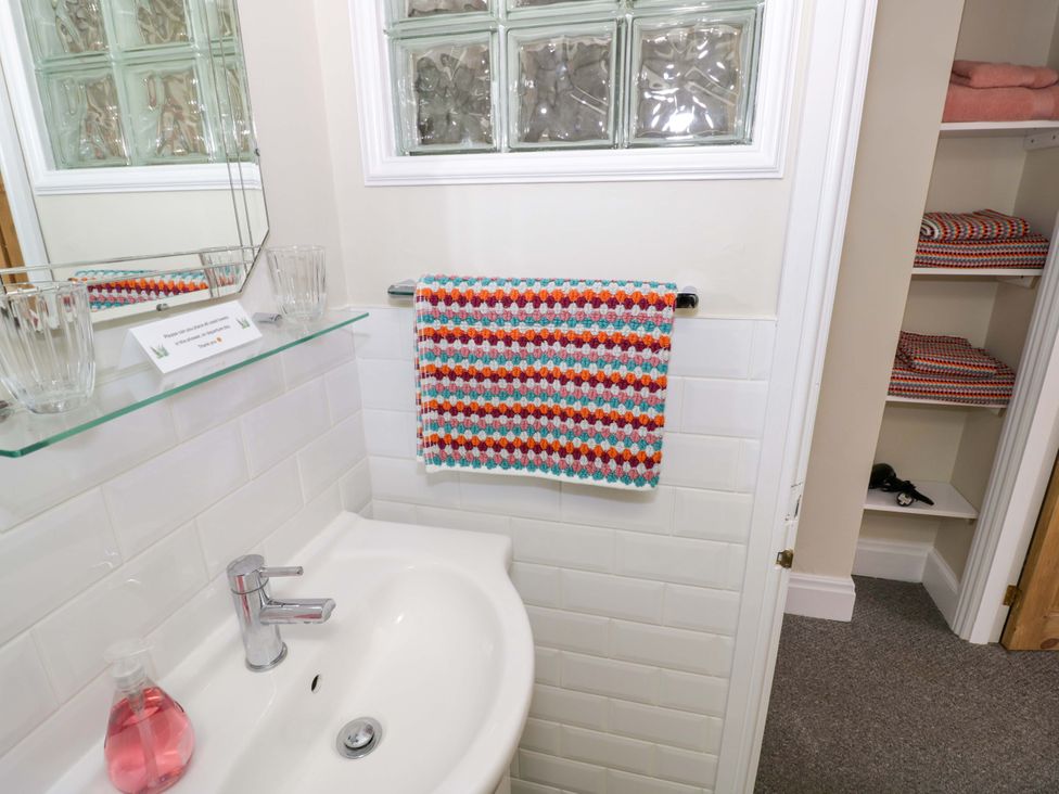 A bathroom with a sink and towel at Fern Cottage Lichfield