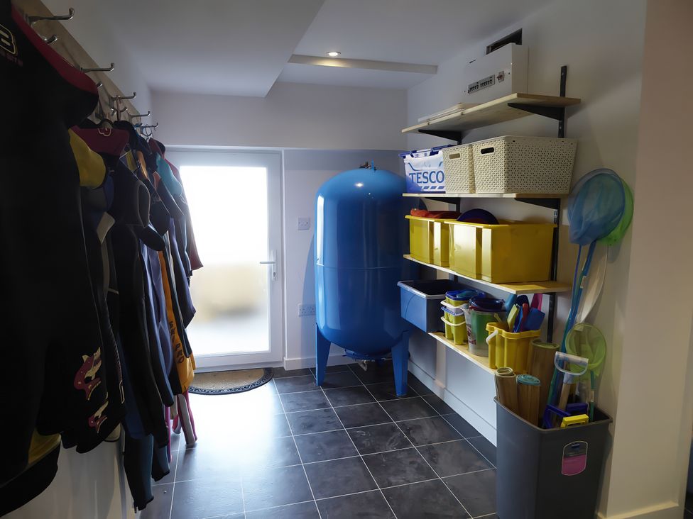 A utility room with storage and wet suits at Gilfach Goed Pwllheli