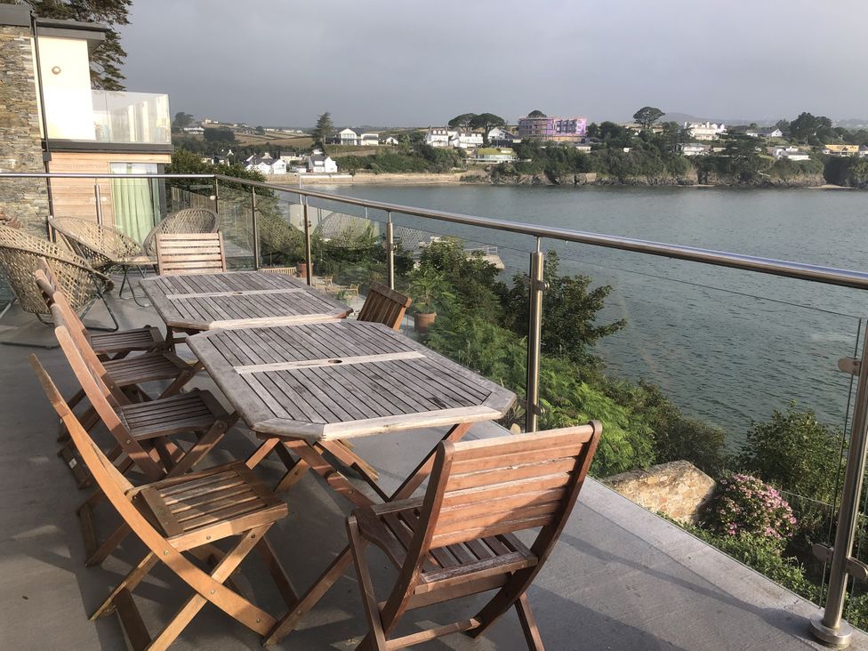 An outdoor seating area with a table and chairs at Gilfach Goed in Abersoch