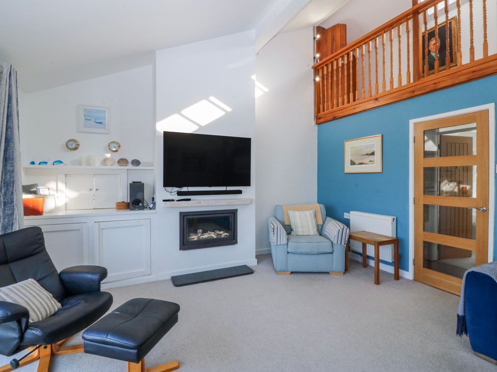 A living room with a tv and seating area at Gilfach Goed Abersoch