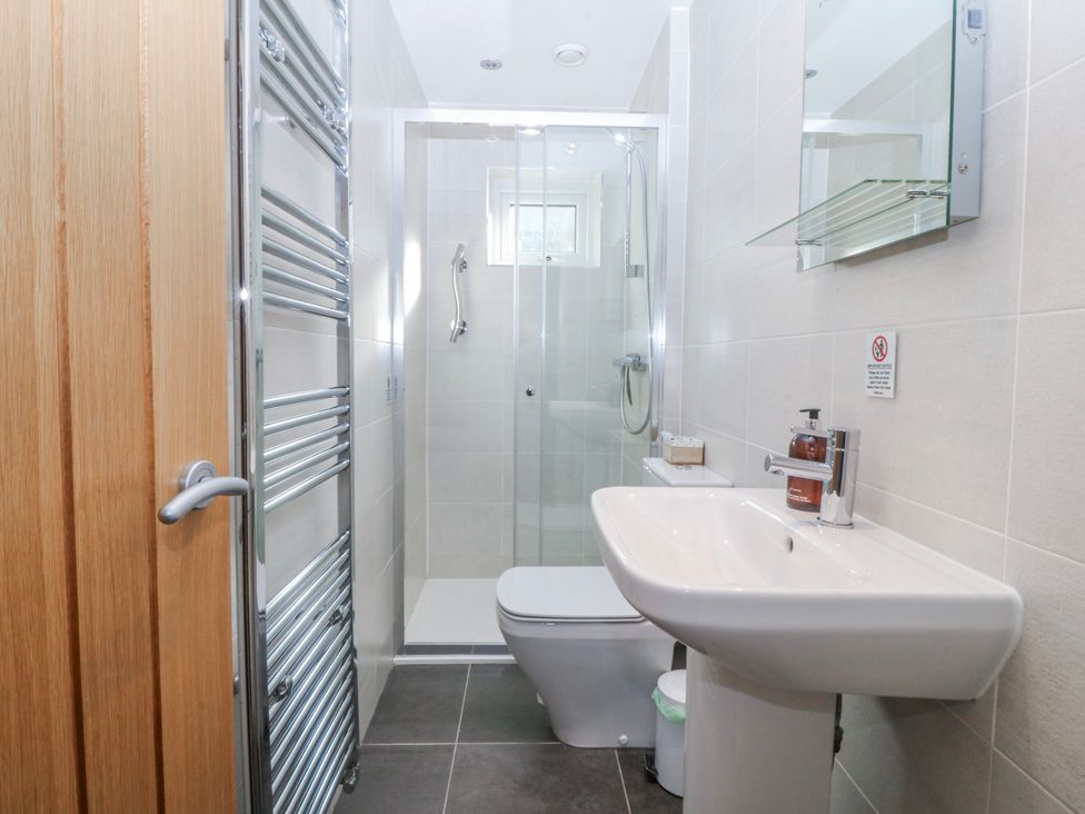 A bathroom with shower, toilet, and sink at Gilfach Goed in Abersoch