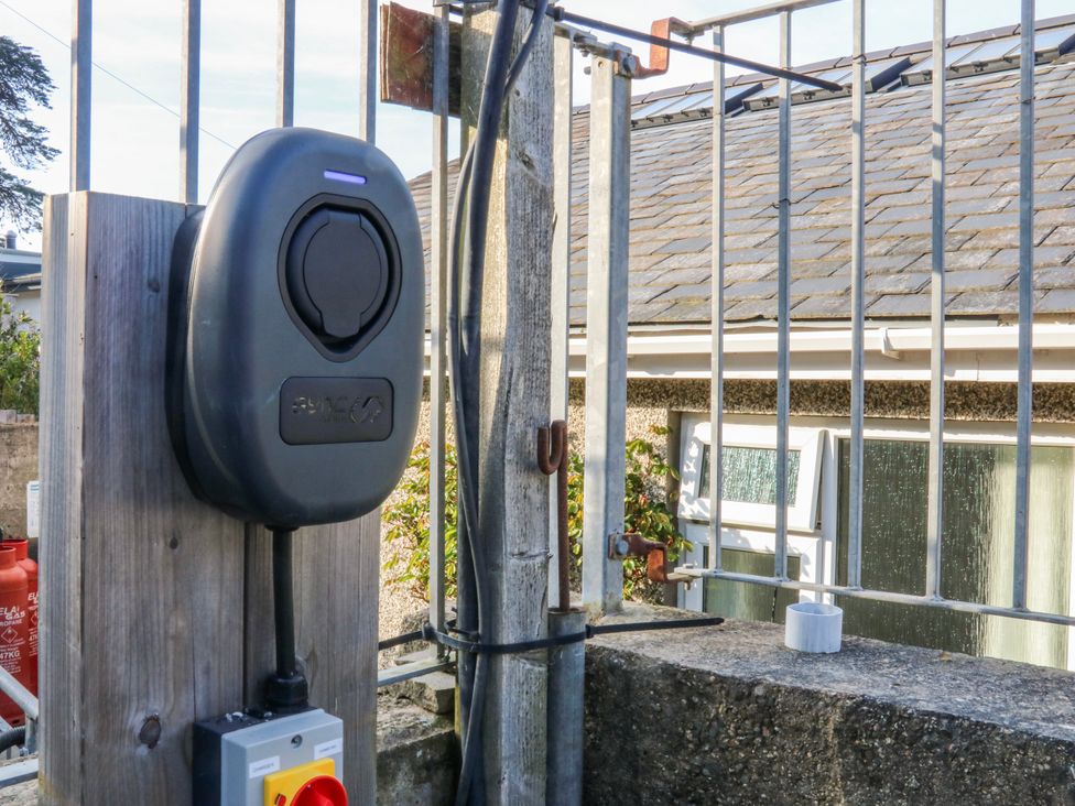 A charging station mounted on a fence at Gilfach Goed in Abersoch