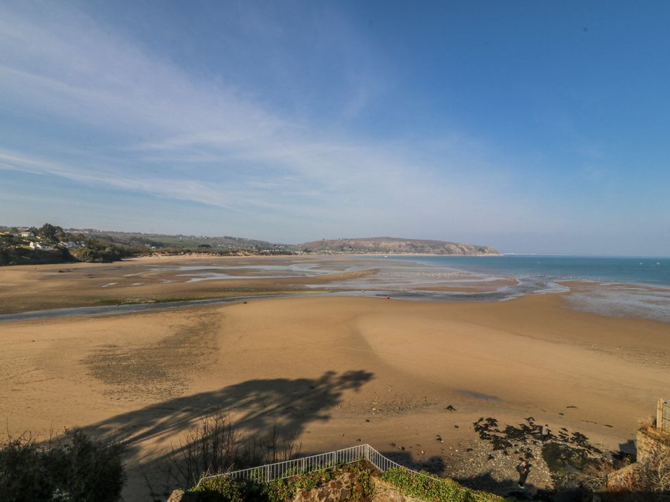A beach with sand and water at Gilfach Goed in Abersoch