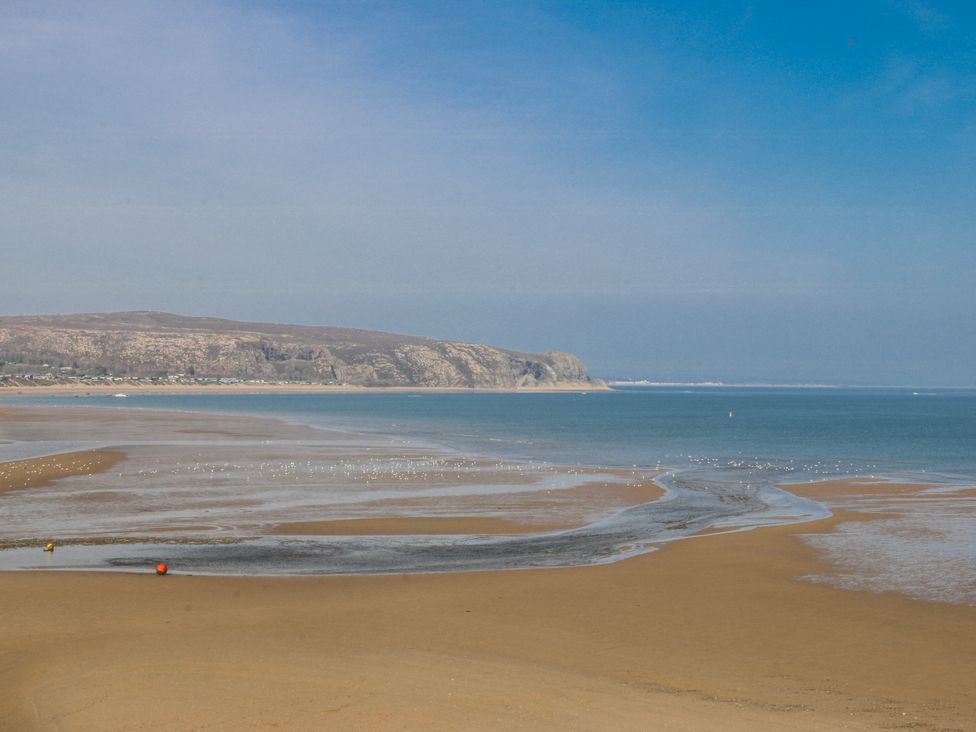 A beach scene with sand and sea at Gilfach Goed in Abersoch
