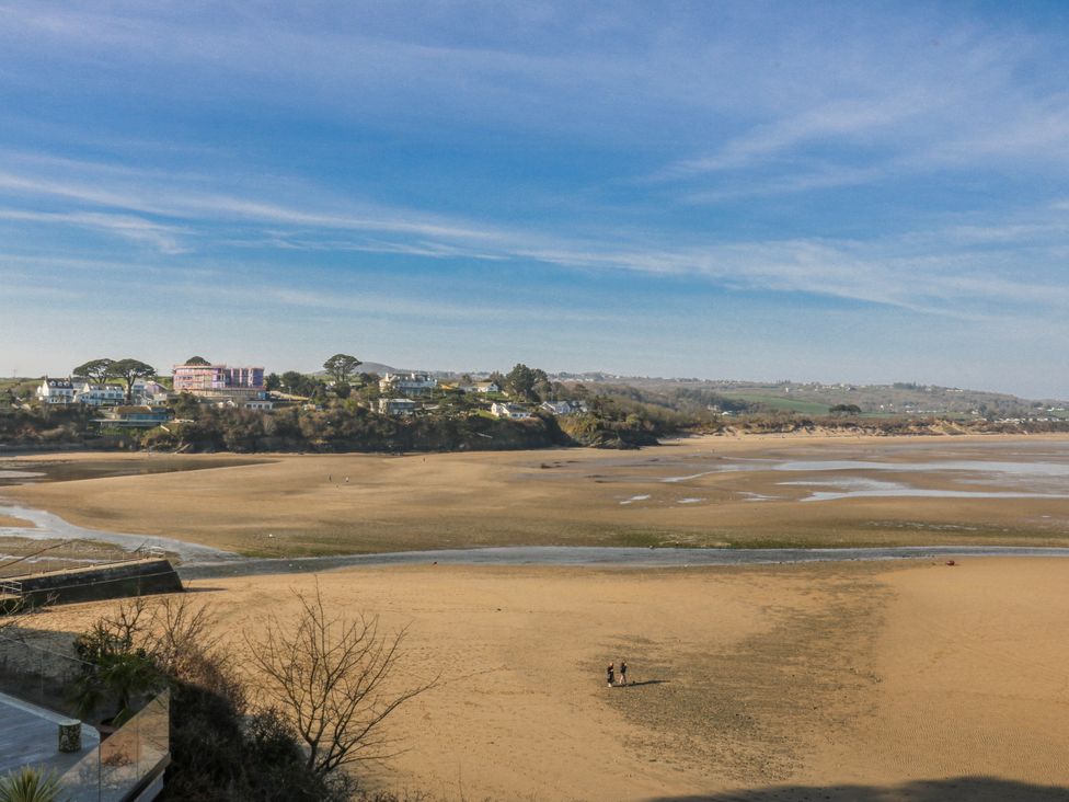A beach view with houses on the shore at Gilfach Goed in Abersoch