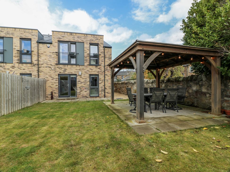 A garden with a gazebo and furniture at 14 Old Market Place Bonnyrigg