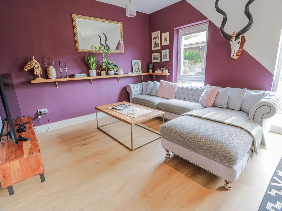 A living room with a sectional sofa and coffee table at 14 Old Market Place in Bonnyrigg