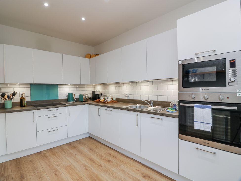 A kitchen with cabinets and appliances at 14 Old Market Place Bonnyrigg