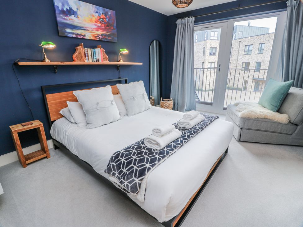 A bedroom with a bed and nightstand at 14 Old Market Place Bonnyrigg