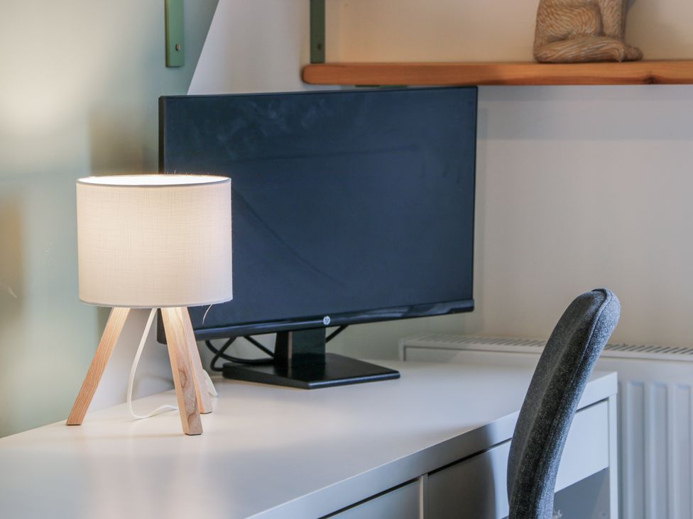 An office with a lamp and monitor on a desk at 14 Old Market Place Bonnyrigg