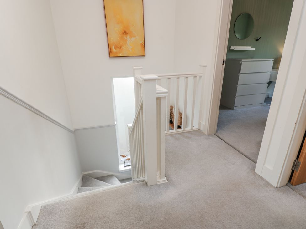 A staircase with a handrail in a hallway at 14 Old Market Place Bonnyrigg