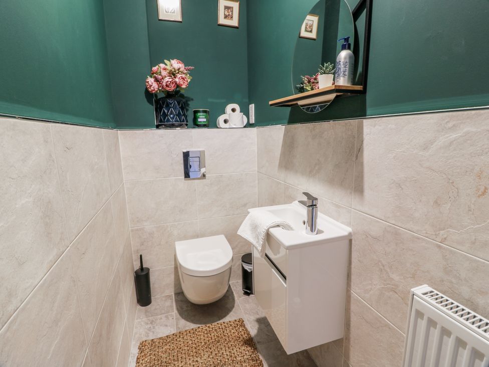A bathroom with a toilet and sink at 14 Old Market Place in Bonnyrigg
