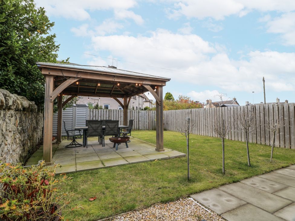 A garden with a gazebo and furniture at 14 Old Market Place Bonnyrigg