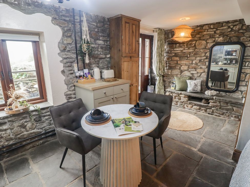 A dining room with a table and chairs at Gwyn Studio in Aberdare