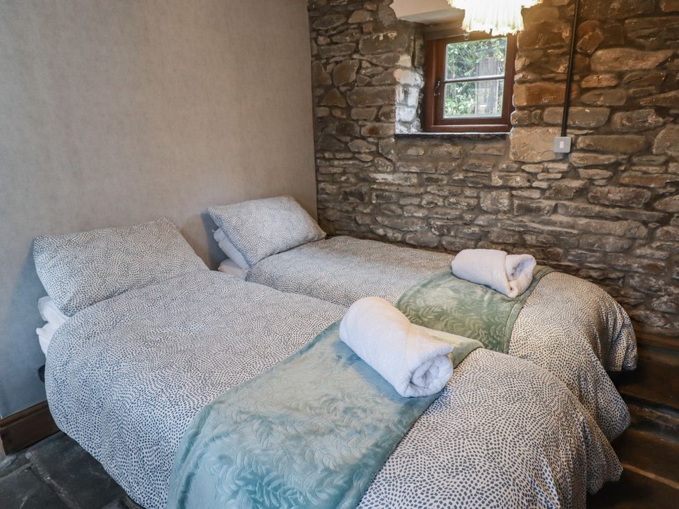 A bedroom with two single beds and a window at Gwyn Studio in Aberdare