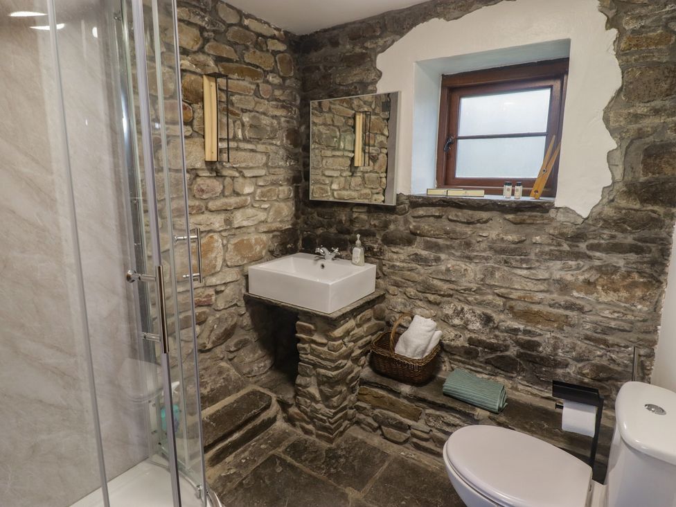 A bathroom with a shower, sink, mirror and toilet at Gwyn Studio in Aberdare