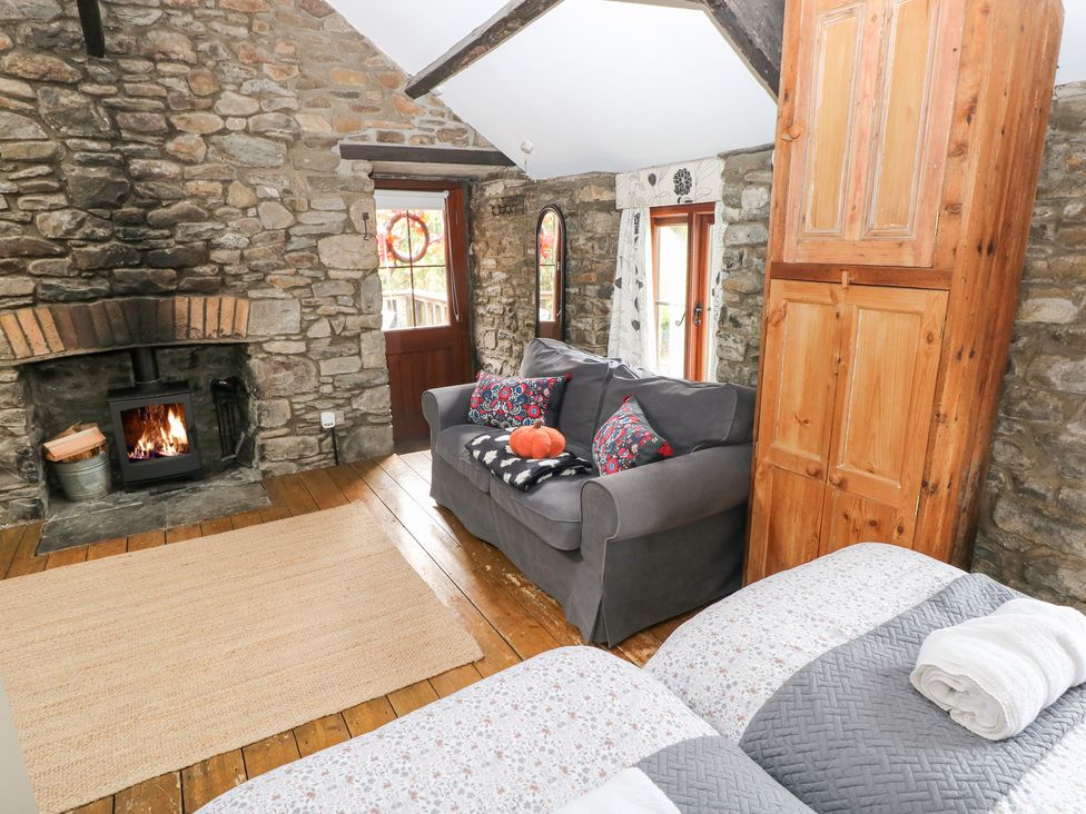 A living room with a fireplace and sofa at Glas Studio in Aberdare