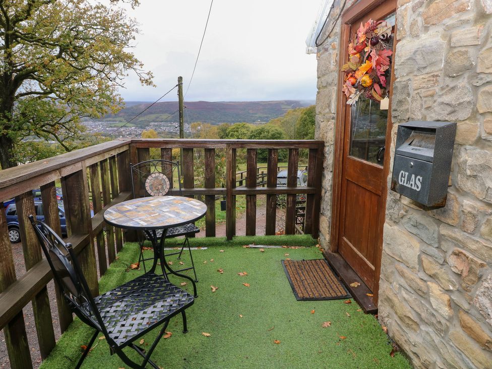 An outdoor seating area with a table and chair at Glas Studio in Aberdare