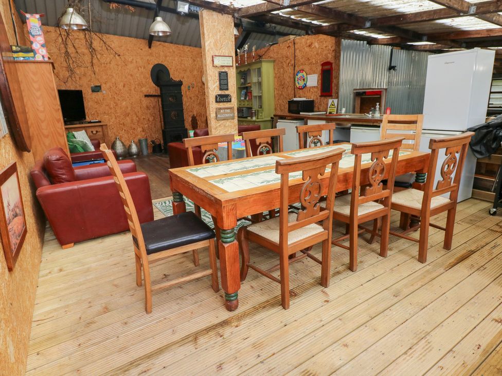 A kitchen with a dining table and chairs at Glas Studio Aberdare