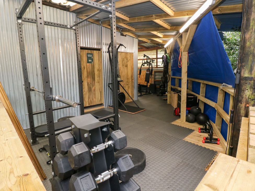 A gym with weights and exercise equipment at Glas Studio in Aberdare