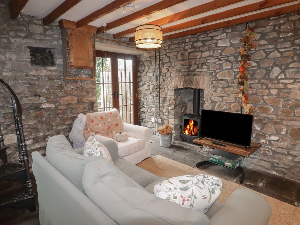 A living room with a sofa and television at Arian in Aberdare