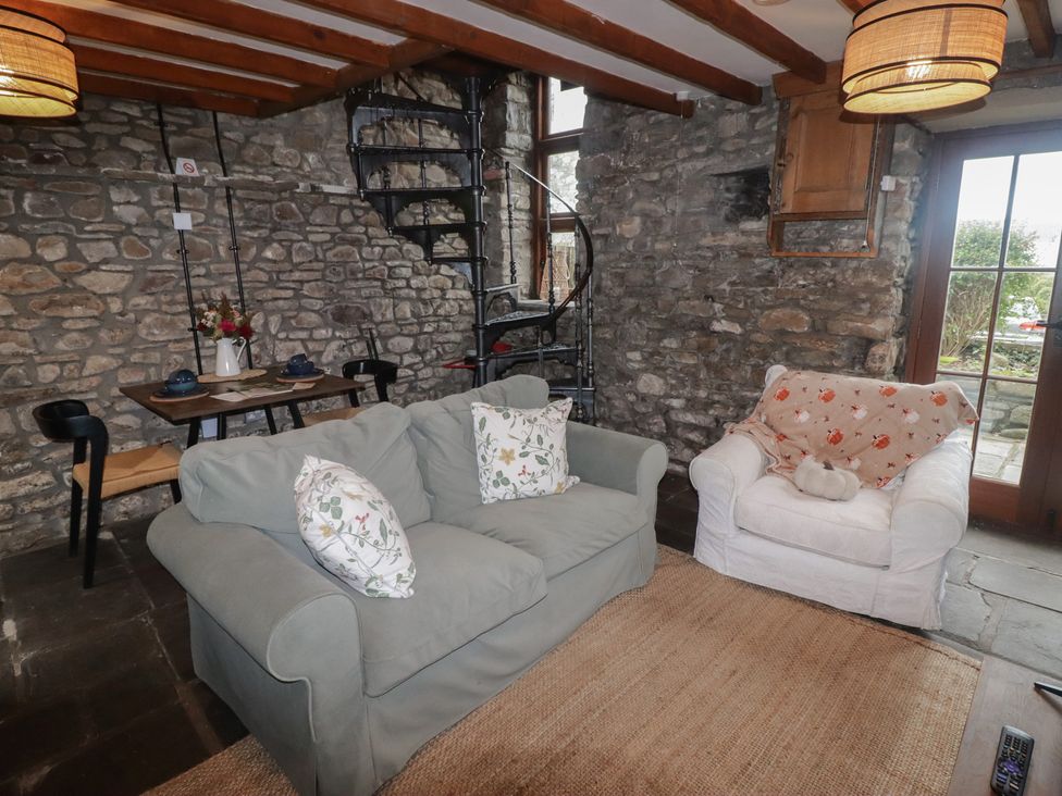 A living room with a sofa and dining table at Arian in Aberdare