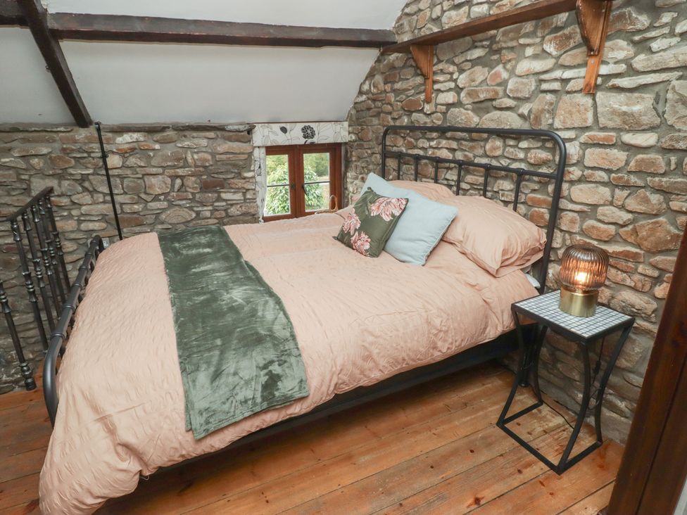 A bedroom with a bed and a bedside table at Arian in Aberdare