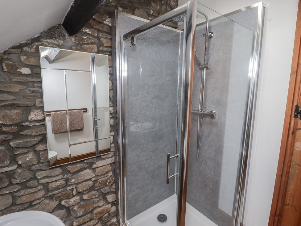 A bathroom with a shower and mirror at Arian in Aberdare