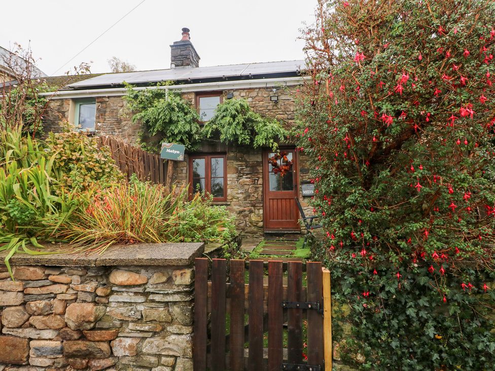 A cottage with stone wall and garden at Melyn in Aberdare