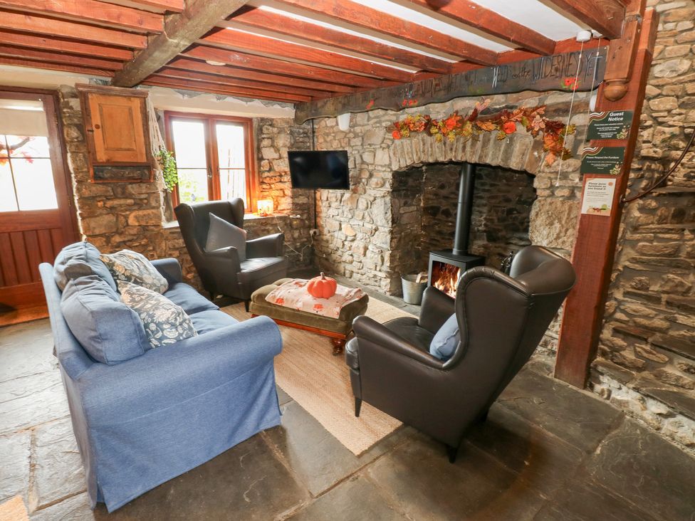 A living room with a sofa and fireplace at Melyn in Aberdare