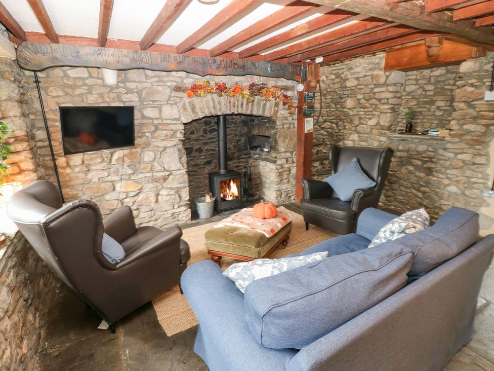 A living room with a fireplace and sofa at Melyn in Aberdare