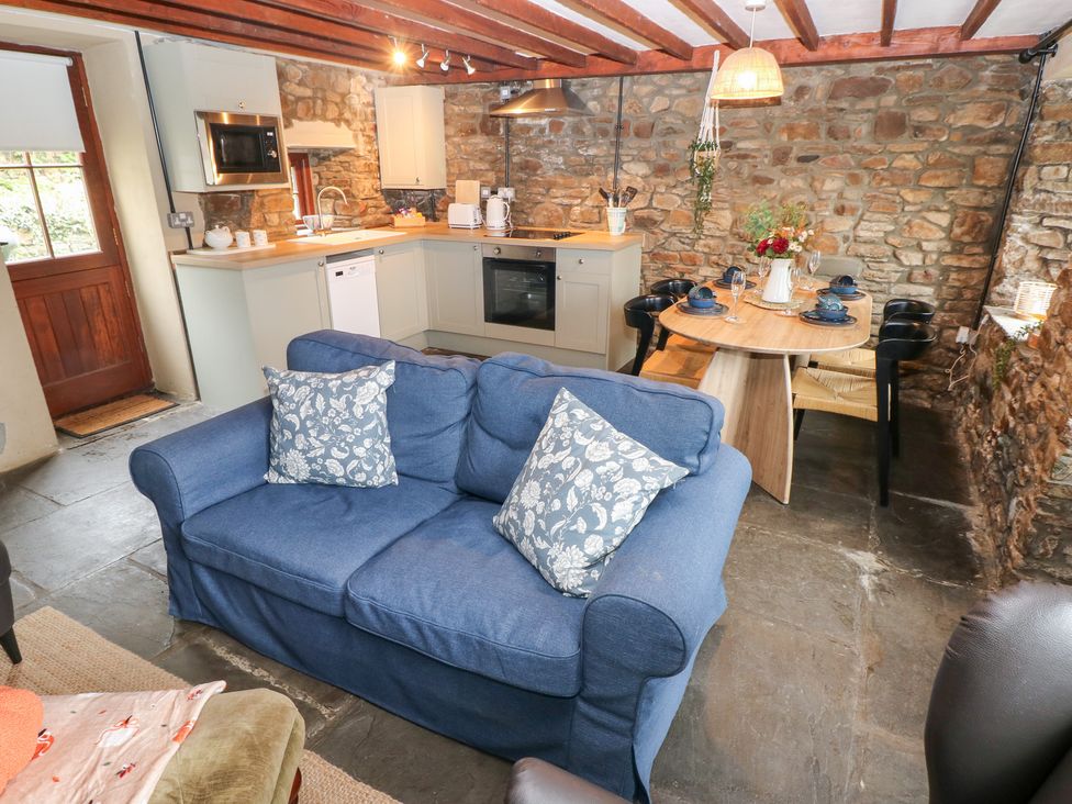 A kitchen with a sofa and dining area at Melyn in Aberdare