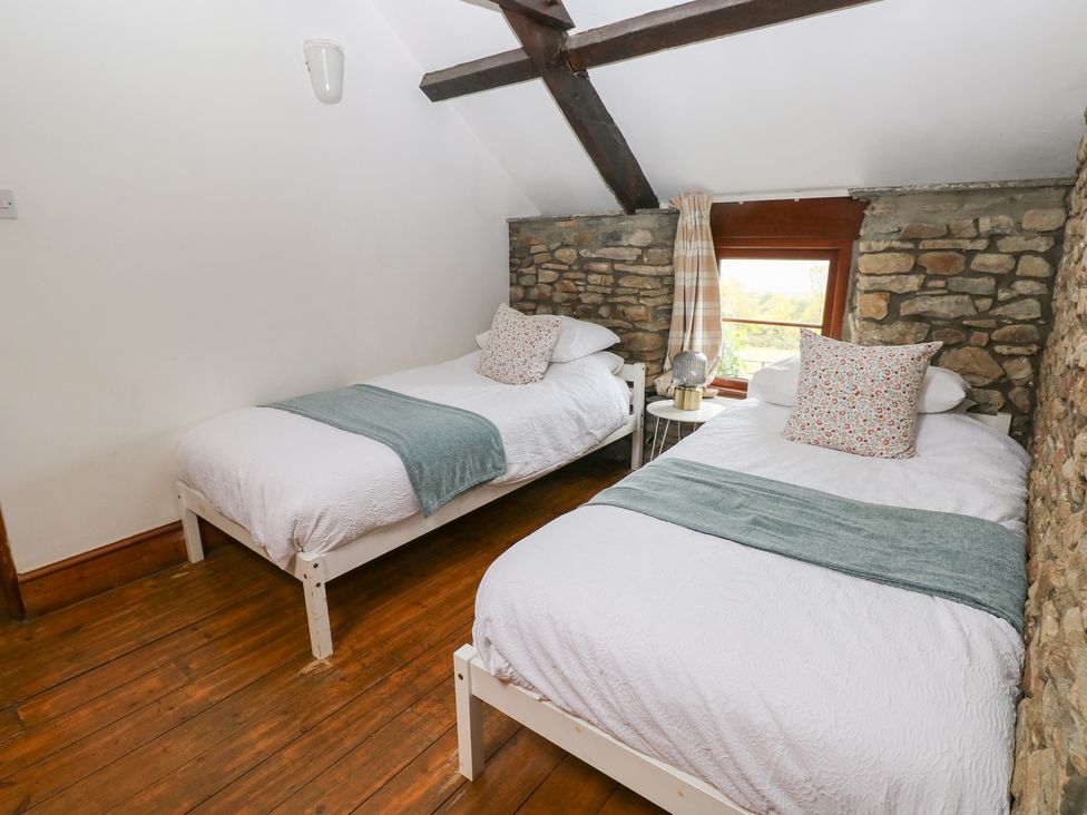 A bedroom with two beds and a window at Melyn in Aberdare