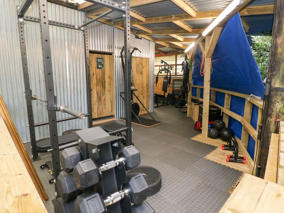 A gym with exercise equipment and weights at Melyn Aberdare