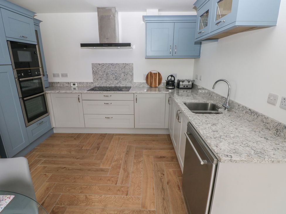 A kitchen with appliances and a countertop at Awelfryn