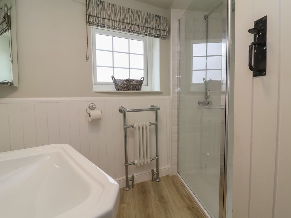 A bathroom with a shower and bathtub at Round Barn in Ilfracombe