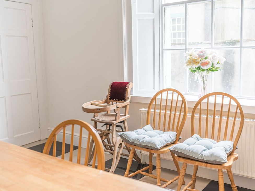 A dining room with chairs and a vase of flowers at 8 Corkickle Whitehaven
