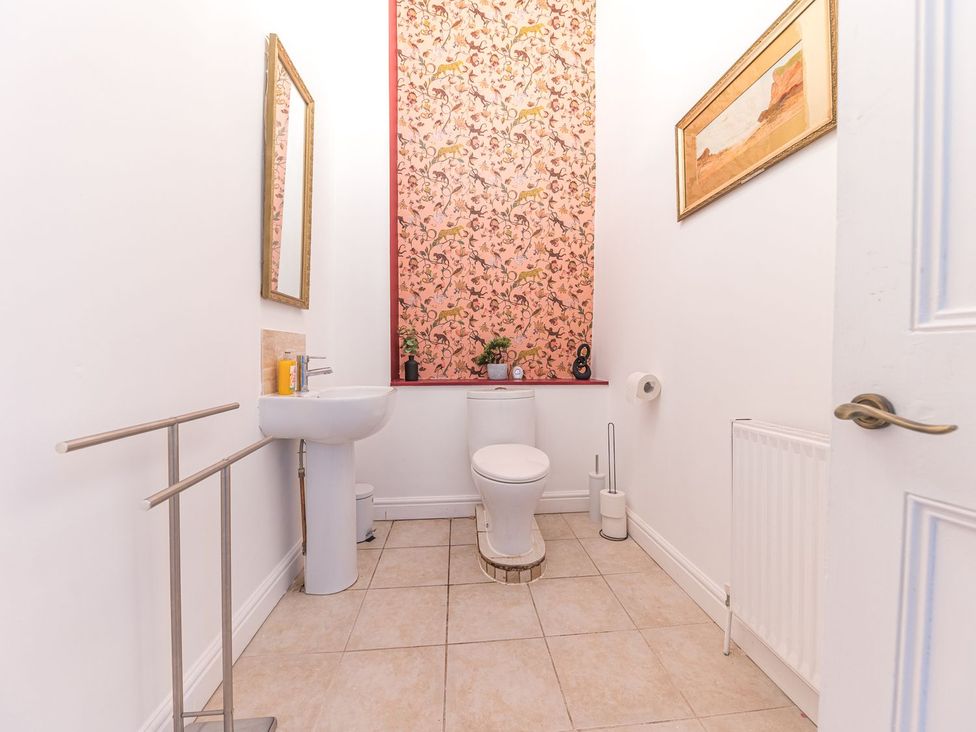 A bathroom with a toilet and sink at 8 Corkickle Whitehaven