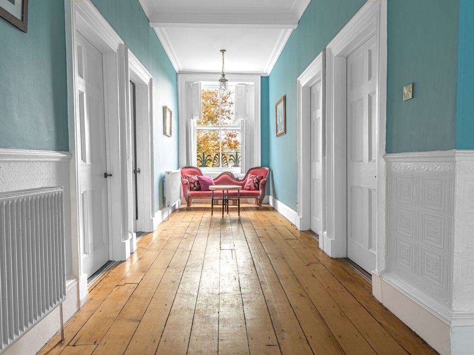 A hallway with chairs and a table at 8 Corkickle Whitehaven