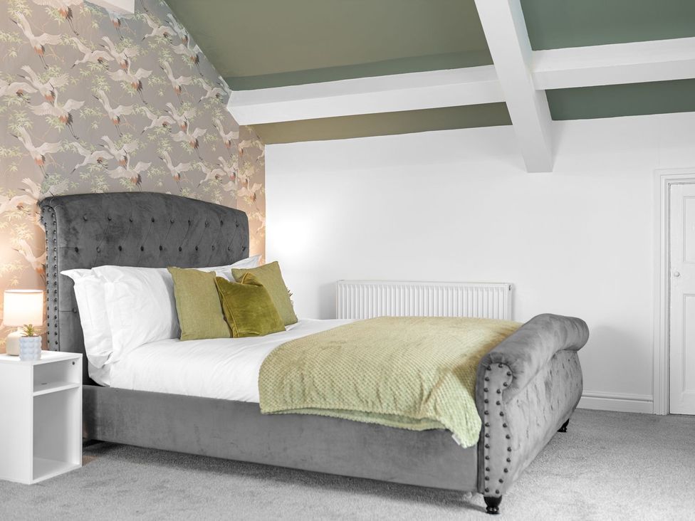 A bedroom with a bed and side table at 8 Corkickle, Whitehaven