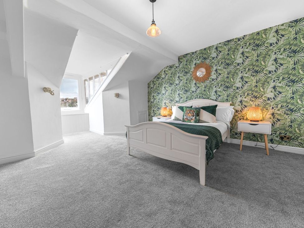 A bedroom with a bed and bedside tables at 8 Corkickle Whitehaven