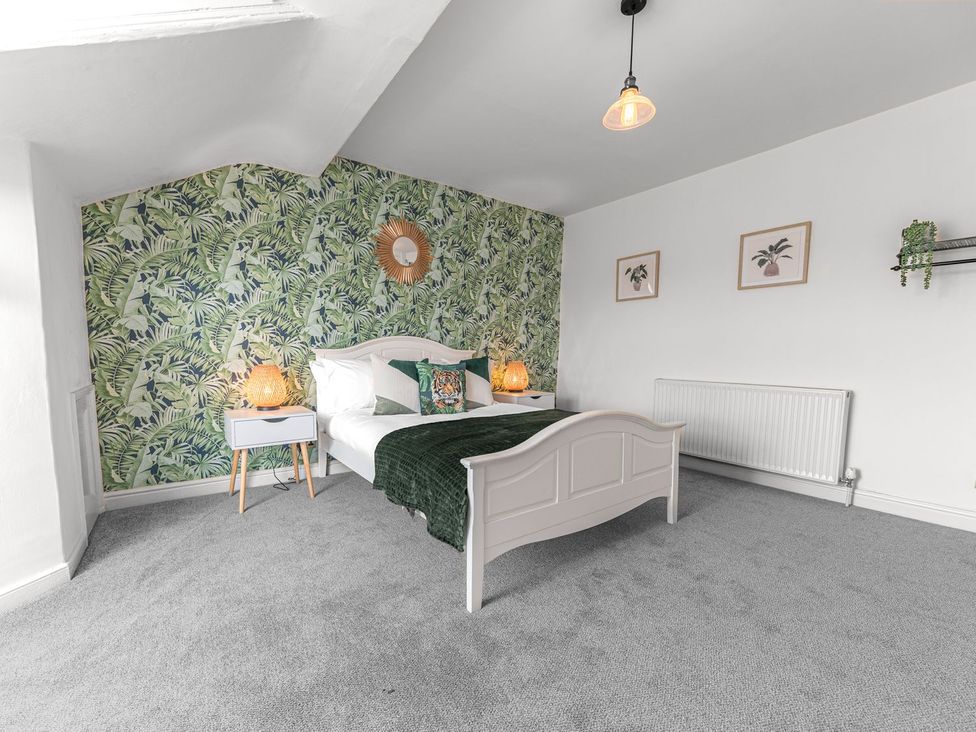 A bedroom with a bed and bedside table at 8 Corkickle in Whitehaven