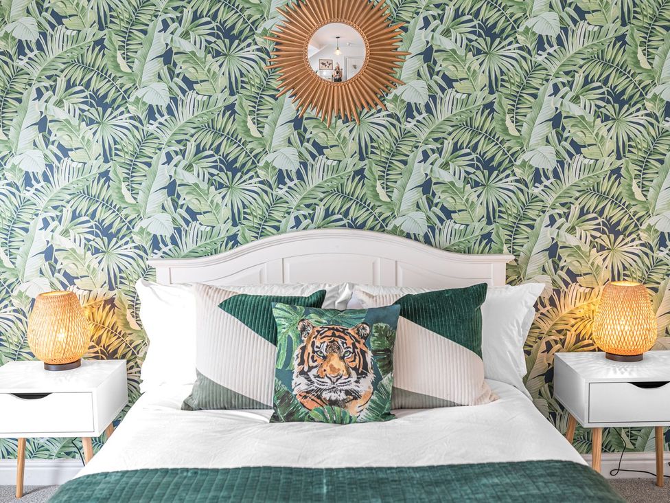 A bedroom with a bed and decorative pillows at 8 Corkickle Whitehaven